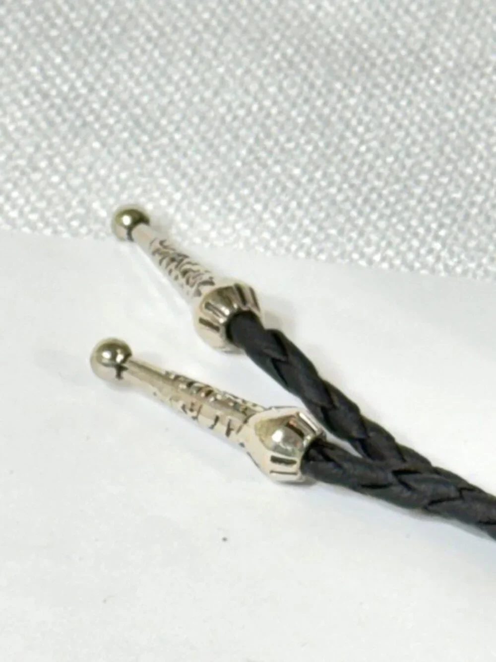 Turquoise-tone, silver-tone and black cord western cowboy bolo tie